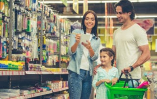 Happy, young family shopping at a retail store.