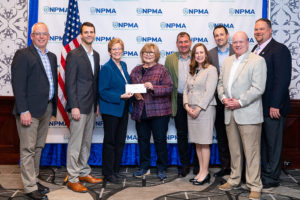 Copesan team presenting a check to Pi Chi Omega in 2019.