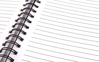Blank lined paper in spiral notebook.