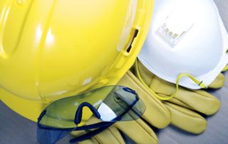 Yellow hard hat, protective glasses, yellow rubber gloves, and PPE mask.