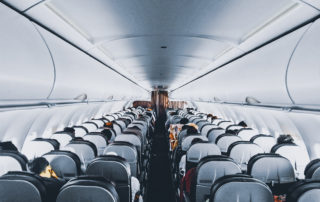 People sitting inside commercial airplane.