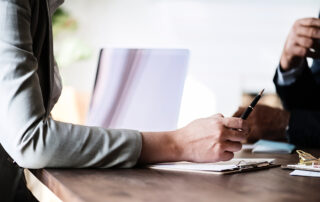 person in business meeting with notepad